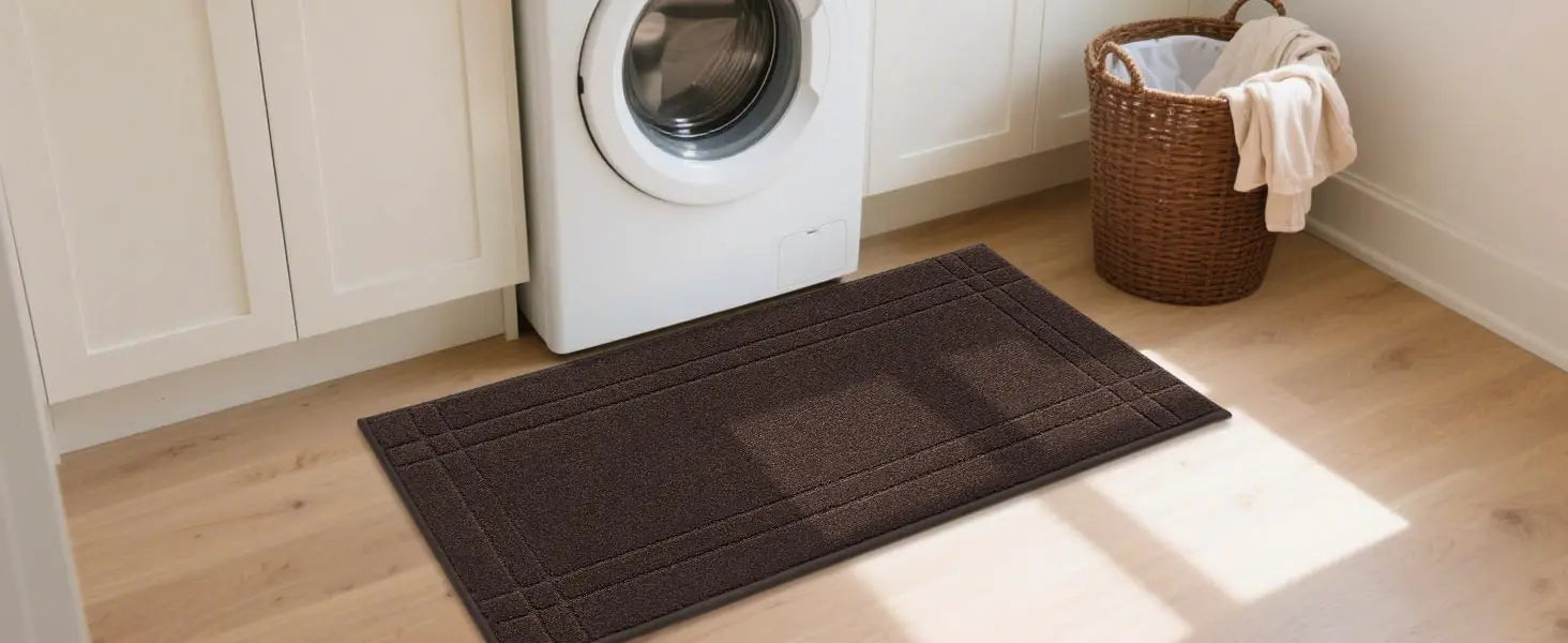 Brown kitchen mat on a wooden floor in front of a washing machine and basket.